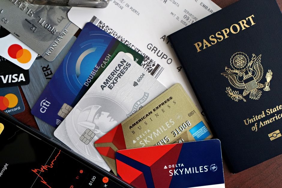 Airlines Profit Beyond Ticket Sales — A collection of travel essentials including a passport, credit cards, and a boarding pa