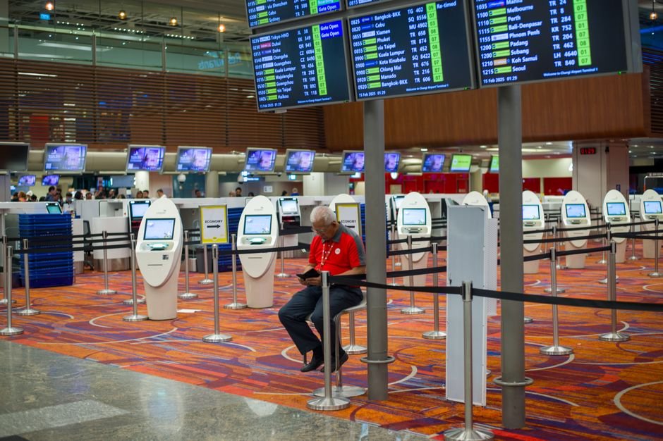 Airlines Profit Beyond Ticket Sales — Busy airport terminal interior with flight information displays and check-in kiosks.