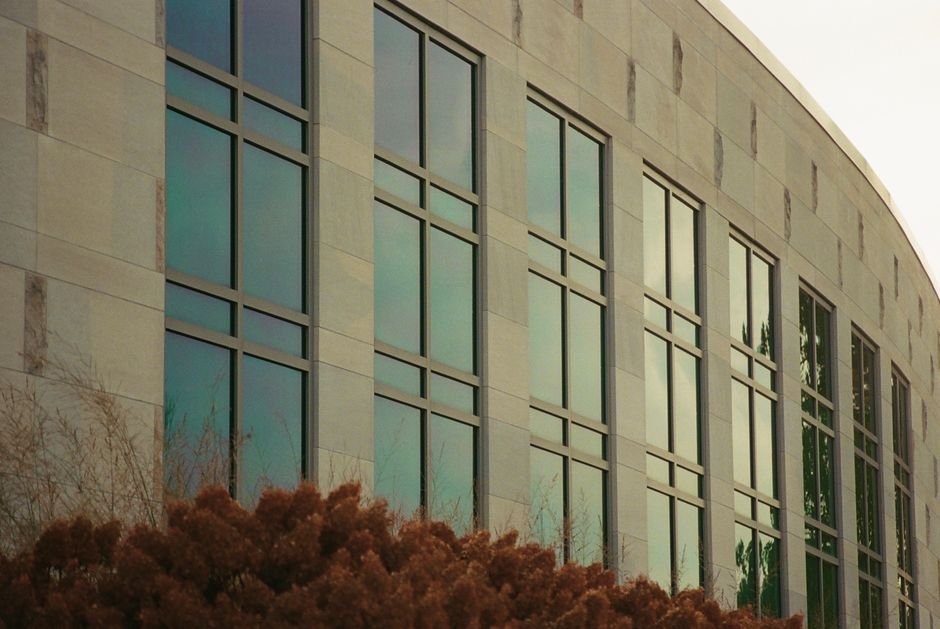 Enron — Close-up shot of a university building's modern glass facade, East Lansing, Michigan.