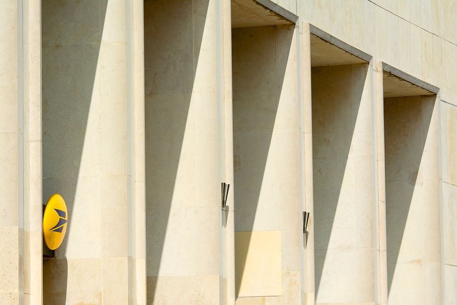 Enron — A modern building facade with striking geometric shadows and minimal design.