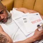 From Bankruptcy to — Sleeping man with financial documents, symbolizing stress and bankruptcy.