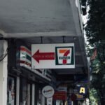 From One Store to Global — 7-Eleven convenience store sign and storefront, open 24 hours in an urban setting.