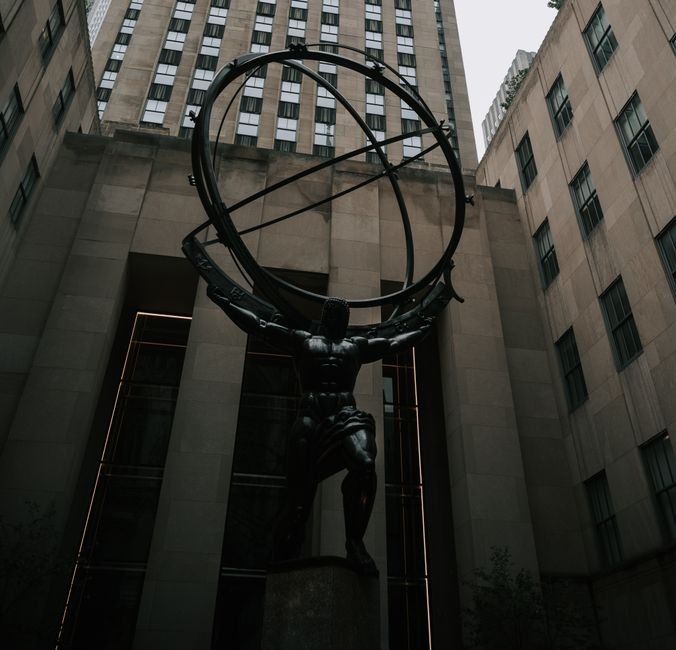 Paradox of Rockefeller — Atlas statue at Rockefeller Center in New York City, showcasing classic architecture and mythologica