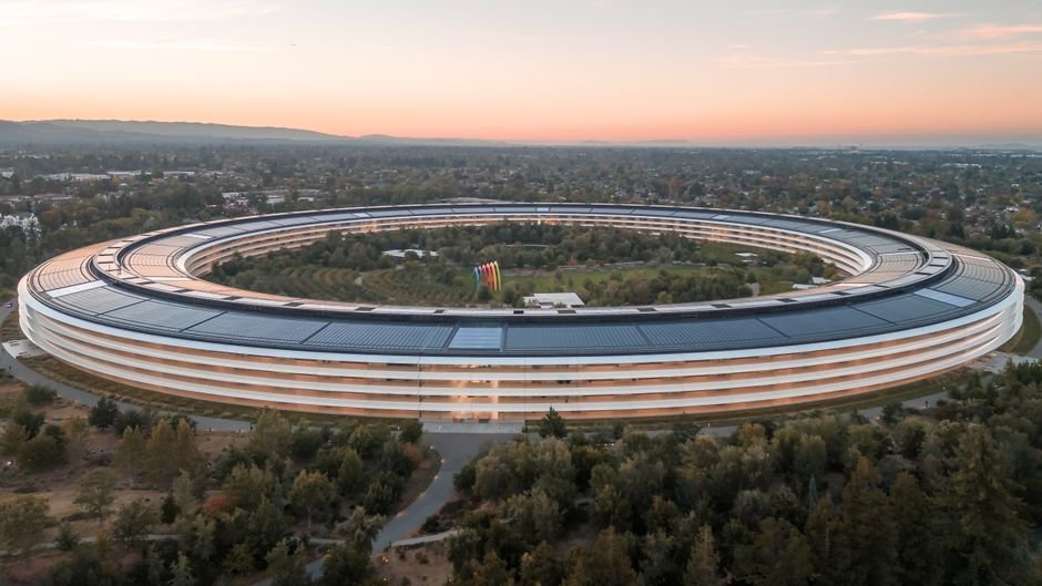 Theranos Tricked Silicon Valley — Stunning aerial view of Apple Park in Cupertino at sunrise, showcasing its futuristic archi