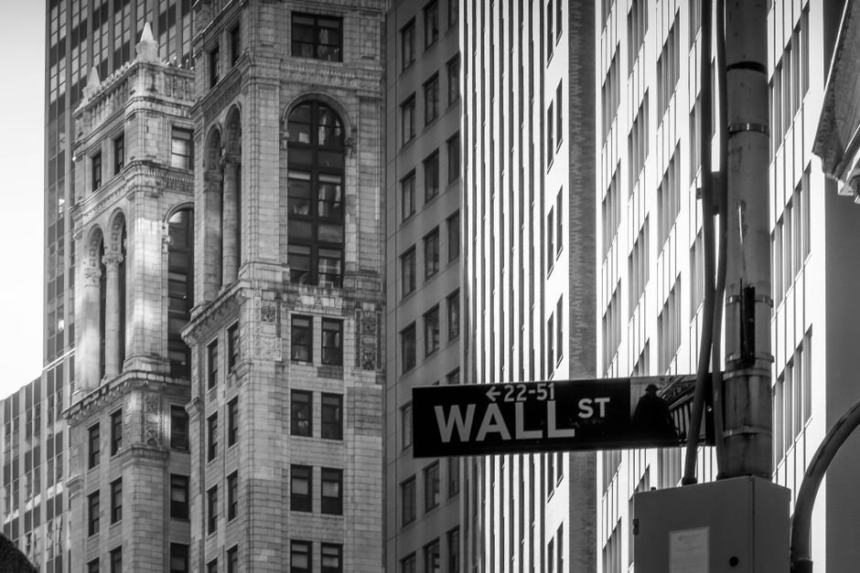 Wall Street stock exchange finance — Black and white image capturing the iconic Wall Street, NYC architecture with street sig
